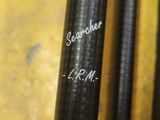 a close up of a pair of fishing rods on a table
