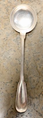 a spoon and spoon rest on a marble table