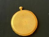 a gold locke on a black surface with a black background