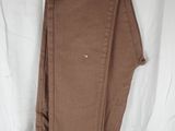 the pants are hanging on a hanger on a white sheet