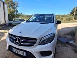 a white mercedes gle parked in front of a trailer
