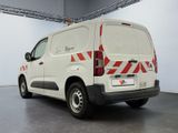 a white van with red and white stripes parked in a garage