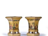pair of vases with figures painted on the sides of them