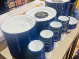 a lot of blue and white plates and cups on the table