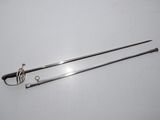 a pair of swords on a white surface