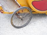a small child ' s car that has been painted yellow and red