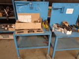 two blue work benches with tools on them in a garage