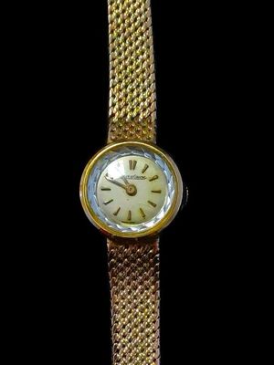 an image of a close up of a wrist watch on a black background