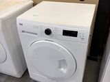 two washers and a dryer in a room