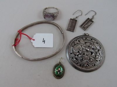 a lot of jewelry on a table with a price tag