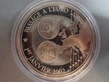 a close up of a coin in a plastic container on a table