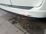 a white car that is parked on the side of the street