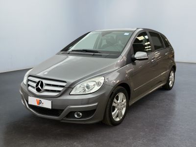 the mercedes b - class is parked in a room with a black floor