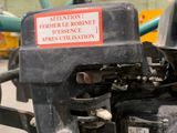 a close up of a tractor engine with a sign on it