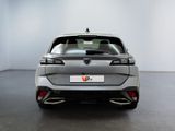 the rear end of a silver car in a white room