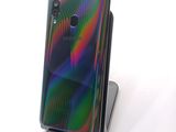a phone that is sitting on a stand on a table