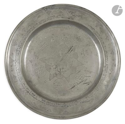 a silver plate with writing on it on a white surface