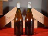 two bottles of wine sitting next to each other on a table
