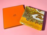 an orange box with a yellow scarf on top of it