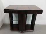a close up of a wooden table with glass shelves on it