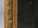 an image of a gold framed mirror with a black background