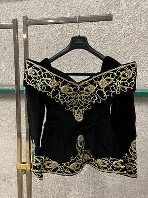 a black and gold dress hanging on a clothes rack
