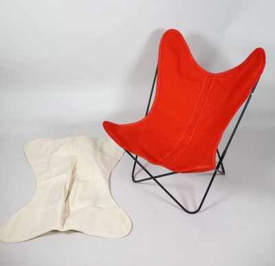 a red chair and a white blanket on a white background