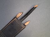 a pair of pencils sitting on top of an old book