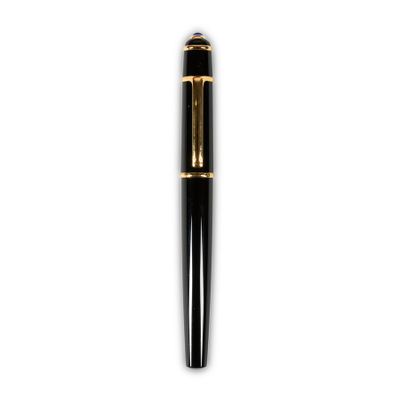 a close up of a pen on a white surface with a white background