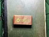 a book in a box with a wooden stamp on it