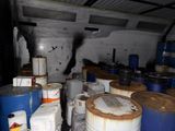 many barrels of oil sitting in a room full of barrels