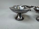 three silver bowls sitting on top of each other