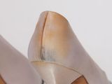 pair of women ' s high heeled shoes on a white surface