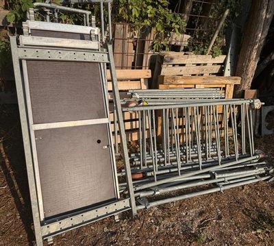 a metal rack with a guitar and a speaker on top of it