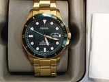 a gold watch in a box with a black face