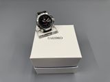 a close up of a watch in a box on a table