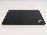 a black laptop on a white surface with a white background