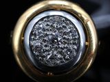 a close up of a diamond ring on a black surface