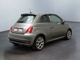 the small car is parked in the empty room of the building