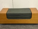 a stack of folded sheets on top of a wooden box