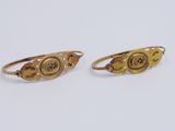 two gold rings with a button on each side and a small button on the other side