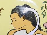 a plate with a painting of a woman and a cat
