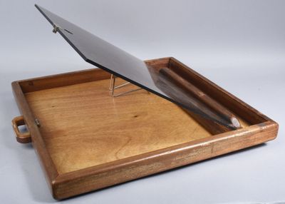 a wooden tray with a laptop on top of it