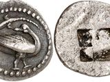 a close up of a silver coin with a bird on it