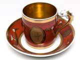 a cup and saucer on a saucer on a white table
