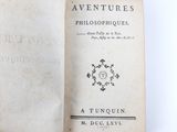an old book with a black and white cover sitting on top of a table