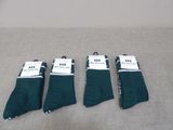 three pairs of green socks sitting on top of a table