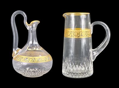 a glass pitcher and a glass jug sitting next to each other