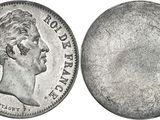 a close up of a coin with a face on it