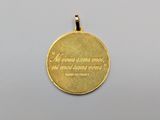 a close up of a gold medal with a quote on it